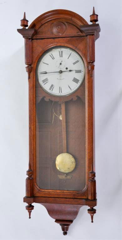 (19th/ 20th c.) Wall Clock: Victorian Atrium-Form Oak cased regulator wall clock with twin finials and roman numerals. Signed Seth Thomas. 46 x 16 x 7 1/2 inches. Condition: Good