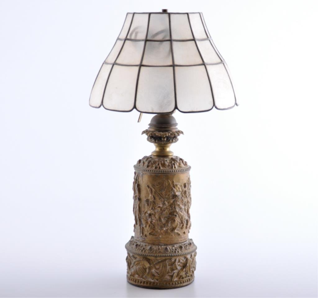 French Brass Lamp Deeply Embossed: Lamp depicts Napoleonic battle scenes. Shell lettered shade. 21 inches (height) Condition: Good
