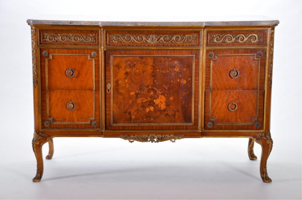(19th/20th c.) French Commode: Turn of the Century French commode, having a marquetry inlaid centered door panel surrounded by gilt bronze ormolu trim, original French marble top. 35 1/4 x 53 3/4 x 22 1/2 d Condition: Good