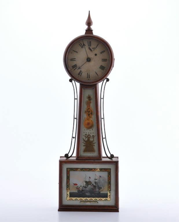 Enoch Titcomb Banjo Clock: Mahogany wall clock signed Titcomb on the face, wooden bezel. throat glass with scrolling devices and the American eagle flanked by brass side arms. Lower tablet depicting the Constitution and the Gue