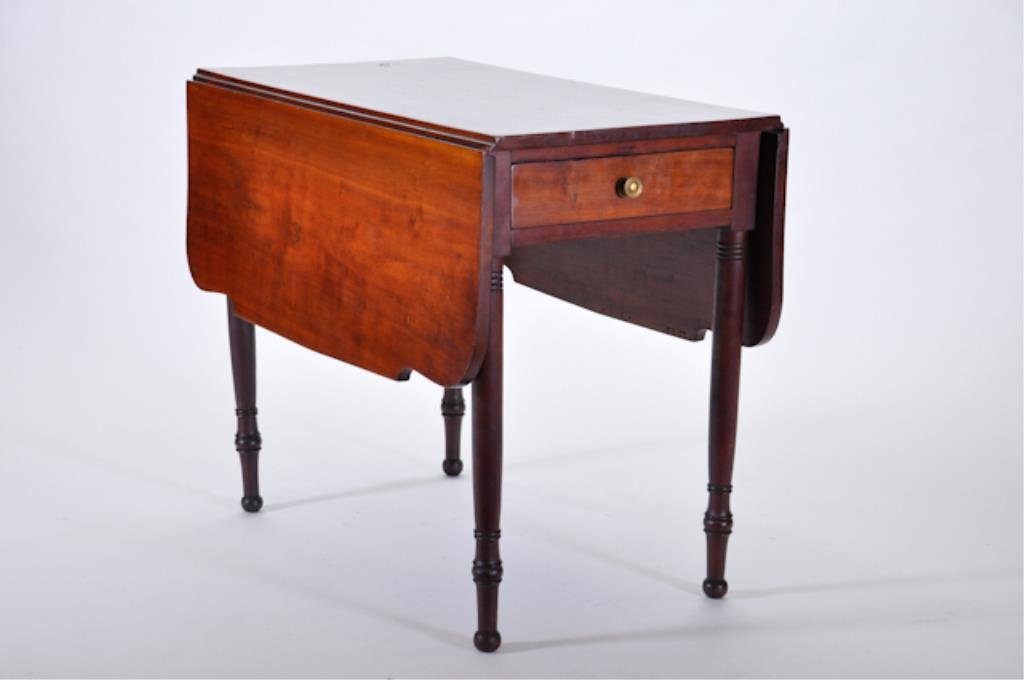 (19th c.) American Pine Drop Leaf Table: Second quarter (19th c.) in a cherry wood finish. The rectangular top, having twin hinged shaped drop leaves above one short end frieze drawer. The whole raised on ring-turned, tapered, cylindrical le