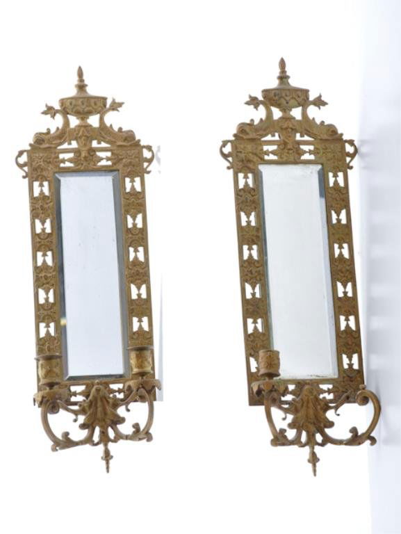 (19th c.) Brass Wall Sconces: Pair of Victorian sconces each with a beveled mirrored back, pierced conforming surround and mounted twin dolphin crests. The terminals, mounted with two lights each (one missing), have curved arms. 2