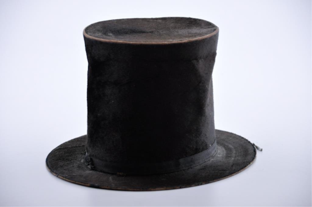 Civil War Period Top Hat: Beaver top hat with a 7 inch rise and 2 1/4 inch brim. Condition: Missing lining, even all over expected wear