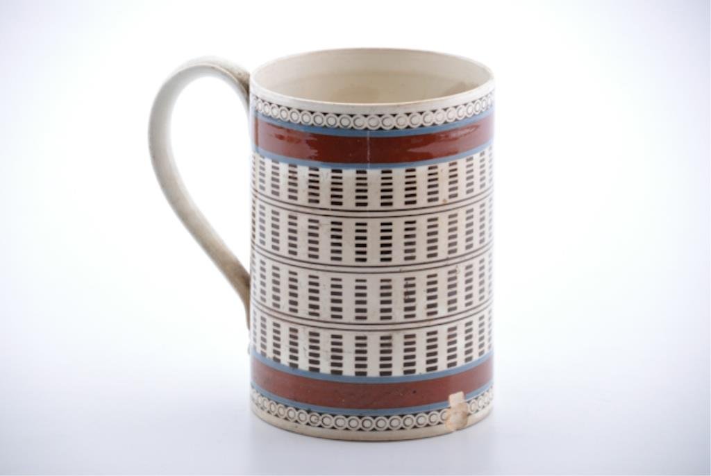 (18th c.) White Mocha Ware Mug: Brown and blue striped with engine-turned black slip design and strap handle, 6 inches (height) Condition: Hairline