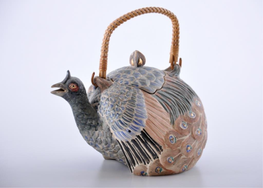 Asian Faience Peacock Teapot: Finely painted peacock-form teapot, marked on the bottom with two calligraphy seal marks, paper label indicates pot was previously sold at Christie's East as part of the O. Lenhart Collection. 4 1/2 x