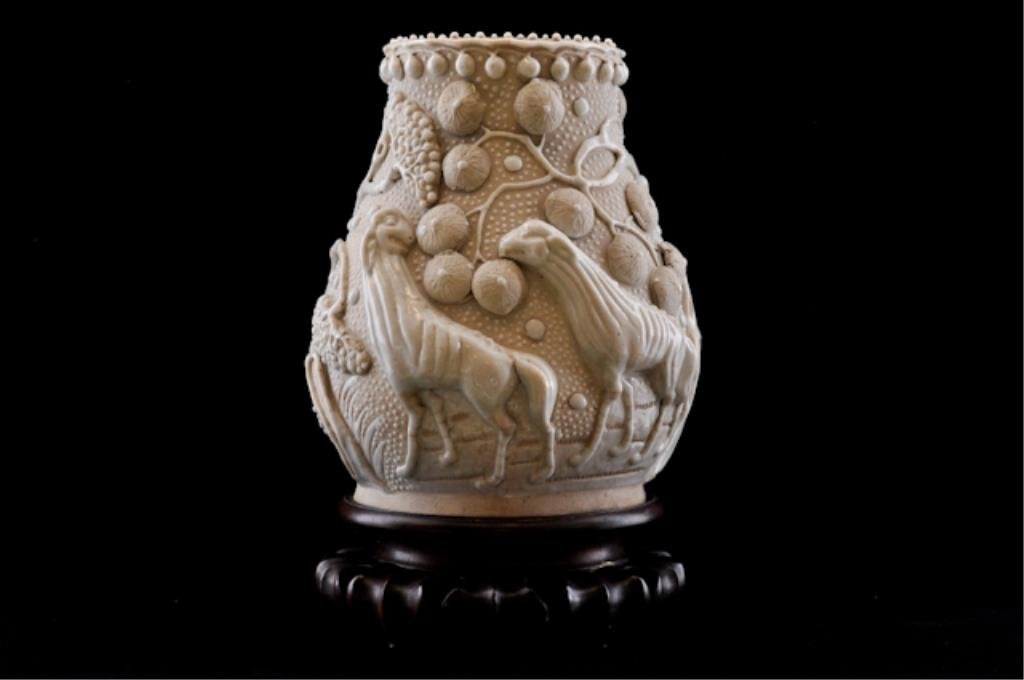 (19th/20th c.) Asian Vase: White glazed stoneware with applied blossoming trees and domesticated animals. Signed in characters on base. 9 x 7 inches. Condition: Good