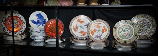 Collection of Plates with Asian Motifs: (9) Ironstone dinner plates with dragon motif, (10) White porcelain with blue carp, (3) Red and Silver plates signed in characters, (2) plates with dragons in black field, (6) dinner and (6) luncheon 