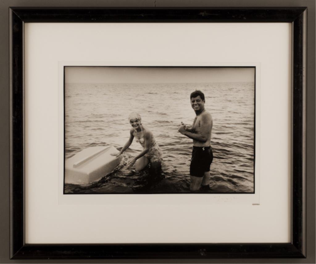 (47) "A Tribute to Jackie" Jacques Lowe: "Jack and Jackie smile to the camera as they stand in the water" Hyannis Port 1960. 11 1/2 x 17 inch photograph signed Jacques Lowe. 22 1/2 x 26 1/2 inches framed. (fading to signature, abrasions to f