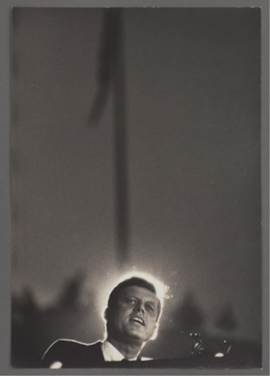 Photograph of John F. Kennedy at the DNC: (1) Large format photograph of John F. Kennedy standing at podium taken in the afternoon of the Democratic National Convention, 13 1/2 x 9 1/2 inches, stamped "photo by Bill Bridges, Beverly Hills", t
