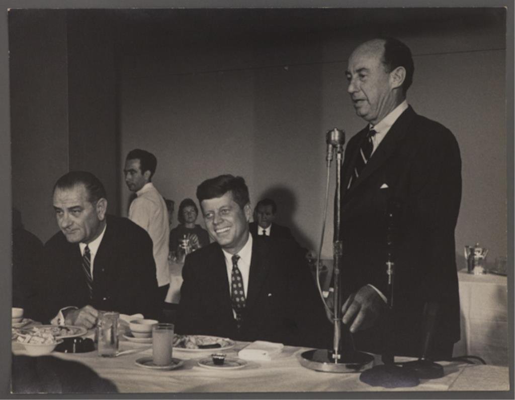 Photograph of Kennedy & Stevenson at the DNC: (1) Large format photograph of Adlai Stevenson addressing a breakfast with John F. Kennedy and Lyndon B. Johnson, 13 3/4 x 10 5/8 inches, stamped "photo by Bill Bridges, Beverly Hills", taken at the D