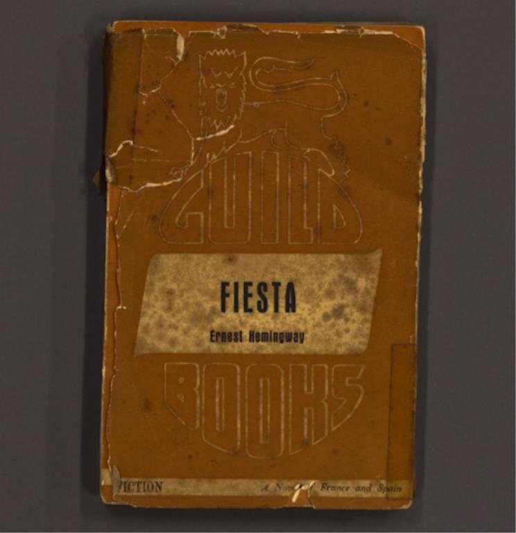 "Fiesta" Hemingway Signed Edition: Hemingway, Ernest. "Fiesta" 12mo, paperback with dust jacket, presentation inscription "For Roberto from his good friend Ernest Hemingway" in ink on title page, Austrian Edition, Guild Books No. A5, p