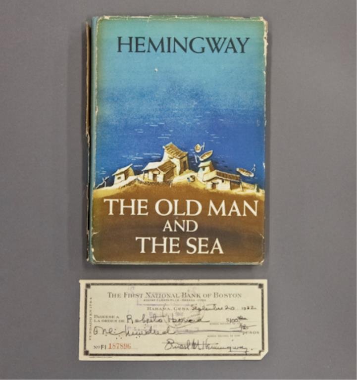 Signed "The Old Man and the Sea" & Check: Hemingway, Ernest. "The Old Man and the Sea," presentation inscription in ink "To Roberto muy toreado en nuestro amor de su amigo Ernest", 8vo 8 1/4 x 6 inches, reprinting of First Edition with P-7.58