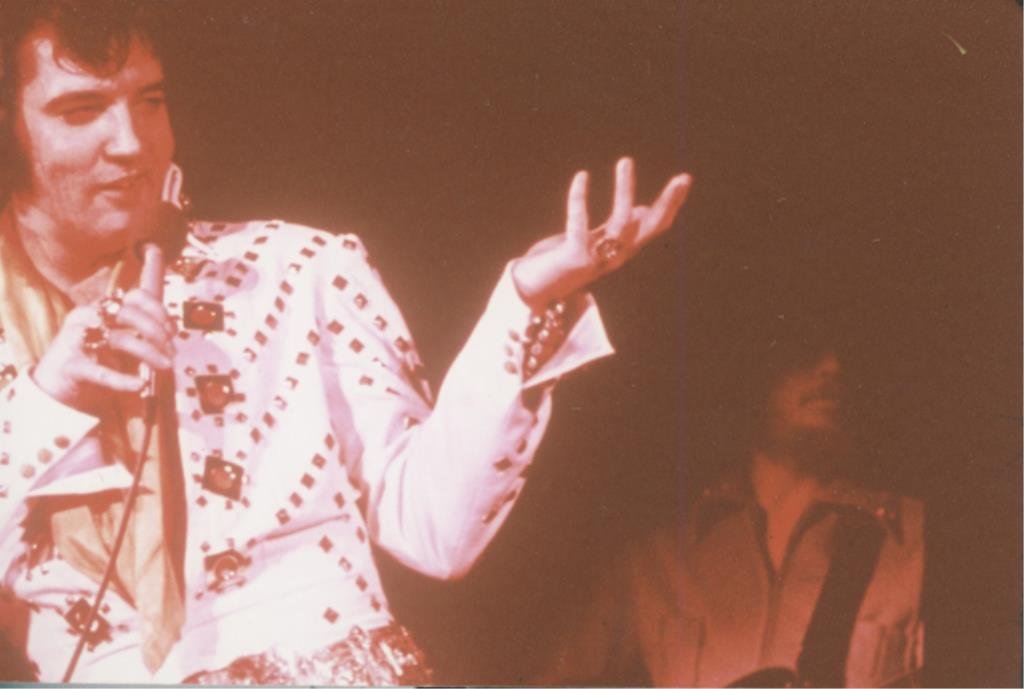 Elvis Presley: (1) 35mm color negative and (1) 35mm color transparency of Elvis Presley singing, together with (1) photograph reprint.