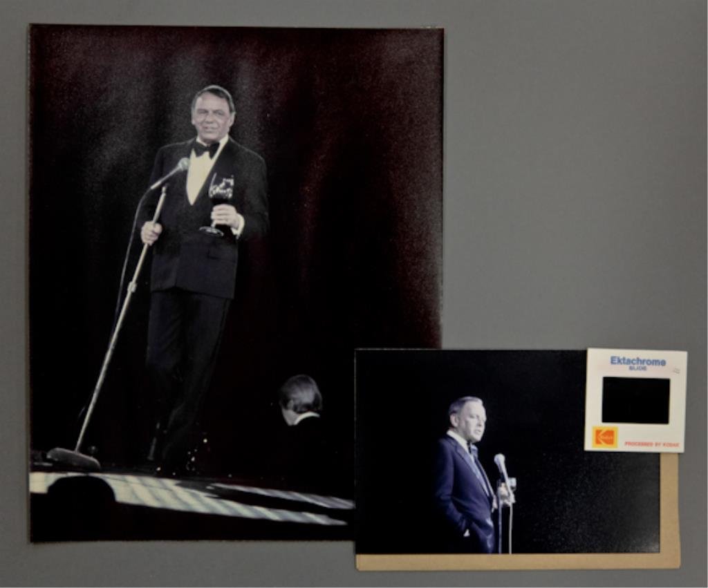 Frank Sinatra: (1) 35mm color transparency of Frank Sinatra, together with (1) 4 x 6 inch photograph reprint. Sinatra is on stage at the microphone with a drink in hand. From Sinatra's "The Main Event" Tour in 1974.