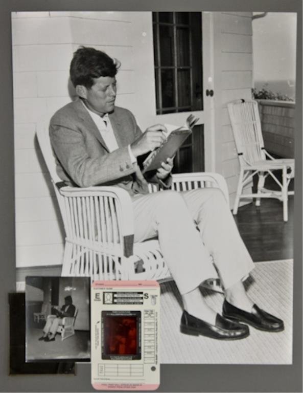 1957-John F. Kennedy: (1) 4 x 5 inch negative, (1) 4 x 5 inch contact photo, (1) 2 x 2 1/2 inch negative, and (1) 16 x 20 inch photograph reprint: a private moment with a good book accentuates summer leisure for John F. Ke