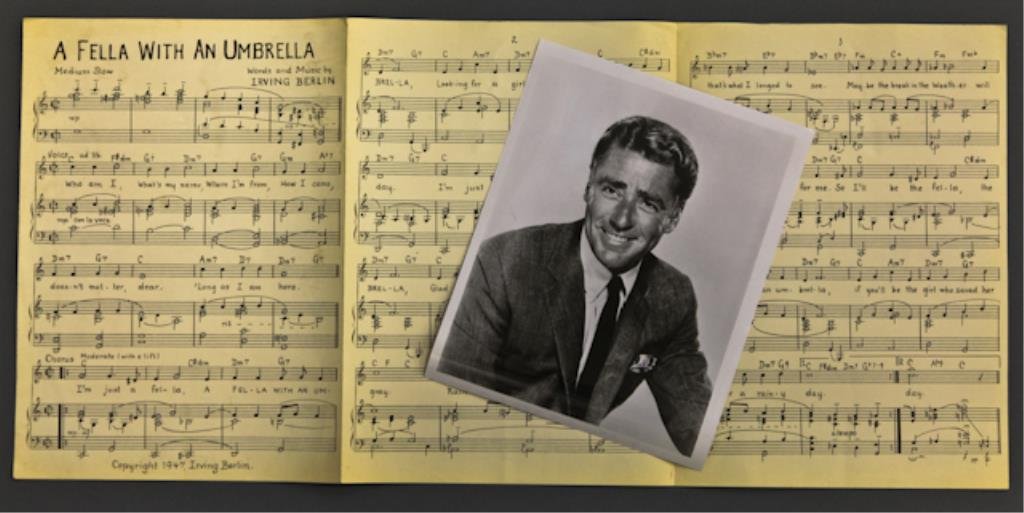 "Sheet Music" From "Easter Parade": "A Fella with an Umbrella", sheet music for Peter Lawford's part in a duet he sung with Judy Garland. (Easter Parade was the highest grossing musical of 1948), and (1) 8 x 10 inch promotional photogra