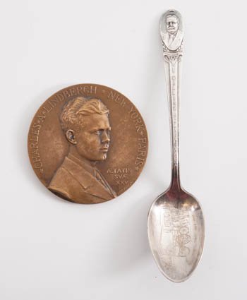 Charles Lindbergh Bronze Table Medal W Taft Spoon: Georges Prud'homme (1873-1947) "Charles Lindbergh- New York~Paris" medallion. 2 3/4 inches diameter. Together with a souvenir spoon of "William Howard Taft 1912 Parcel Post Act" by Rogers MFG Co. Prov