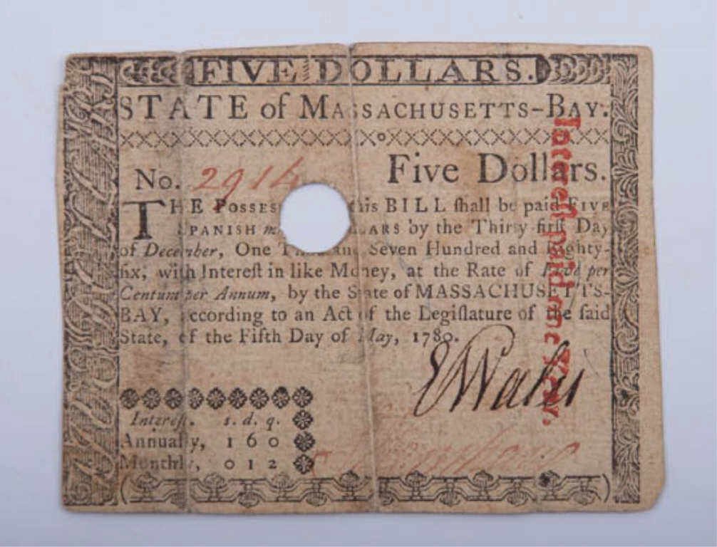 Massachusetts Bay Five Dollar Bill: Issued by State of Massachusetts Bay (1774-1780), "according to an Act of the Legislature of the said State, of the Fifth Day of May, 1780." 2 7/8" x 3 5/8". Three signatures. Condition: Worn with hol