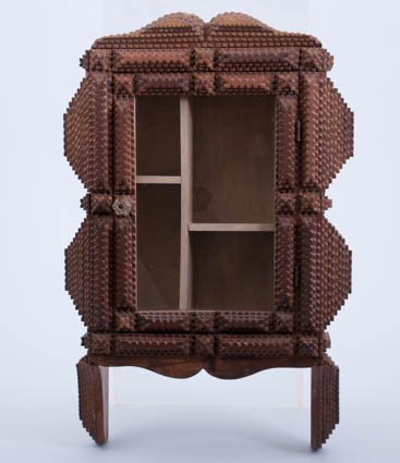 Tramp Art Wall Cabinet: Early (20th c.) hanging cabinet with glazed door, glass knob and fitted what-not shelves. 23 x 16 x 5 inches. Condition: Slight wear.