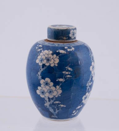 Chinese Covered Jar: White flowers on blue, 5 1/2" high. Condition: Top broken and re-glued.