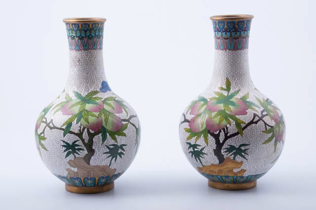 Pair of Chinese Cloisonne Vases: Bat and flower design on white background. Approximately 12 1/2" high. Signed tablet underneath. Condition: Good