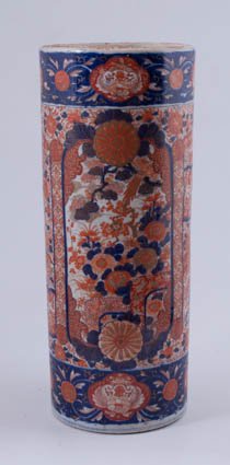 Japanese Imari Umbrella Stand: Cylindrical form porcelain, red and blue floral design over white background. 24" high. Condition: Good