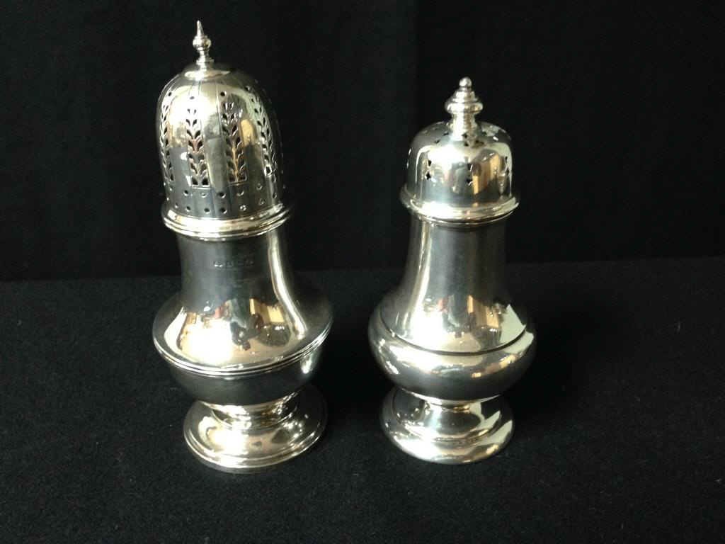 Sterling Sugar Shakers: 2 Sterling silver sugar shakers. 7 inches and 6 inches. 11 Troy ozs. Condition: good