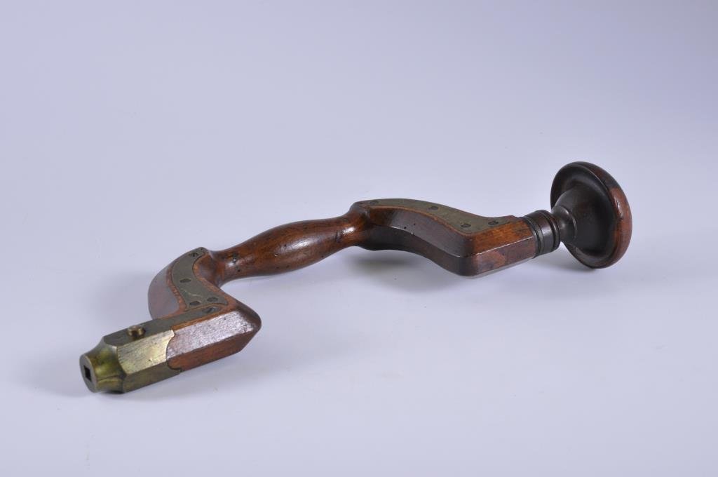 Brass Plated Brace: 14” tall with a 4” sweep. Lignum Vitae head. The brace handle does have a few old worm holes. Condition: good