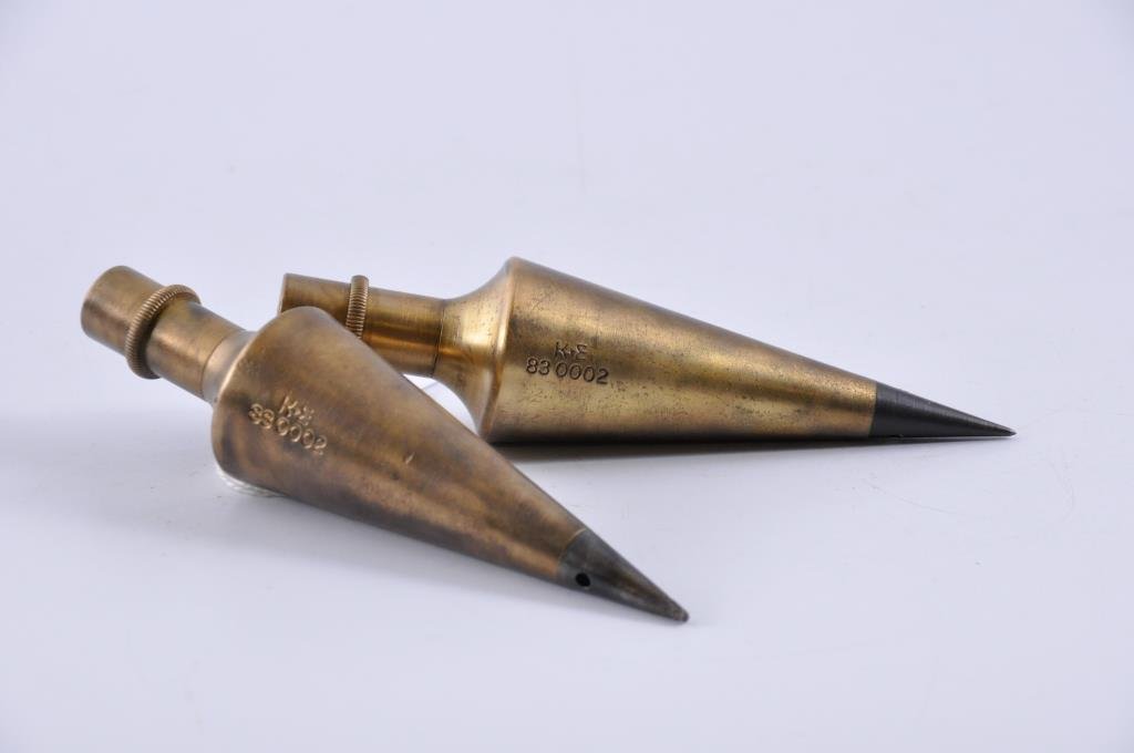 Two Keuffel & Esser Company Plumb Bobs: Identical brass and iron tipped 4 ½” long plumb bobs, #83 002 Condition: very good