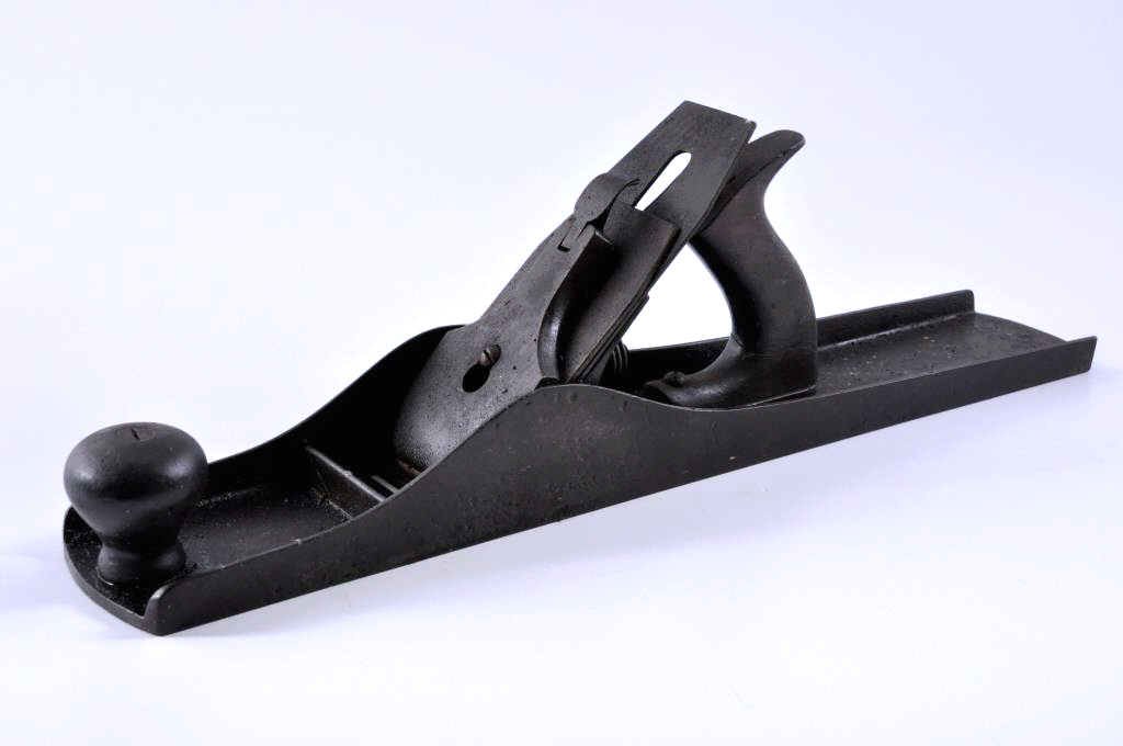 Stanley Sweetheart Era Iron Jointer Plane: 18” x 2 1/2” jointer plane. The blade has a Stanley Sweetheart era mark. The rear handle is cracked through. Condition: fair