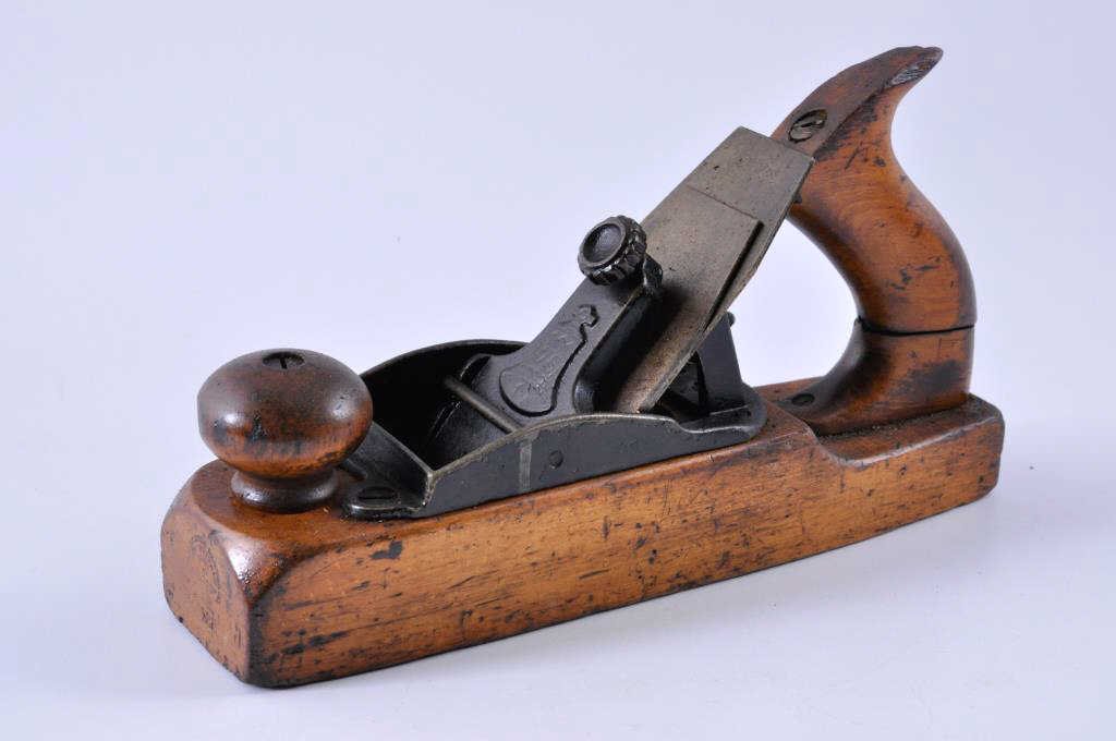Stanley Rule and Level Company Wood Bottom Plane: 10” x 2” Stanley plane #135. The front knob is in good condition, and the rear handle is cracked all the way through. Condition: fair