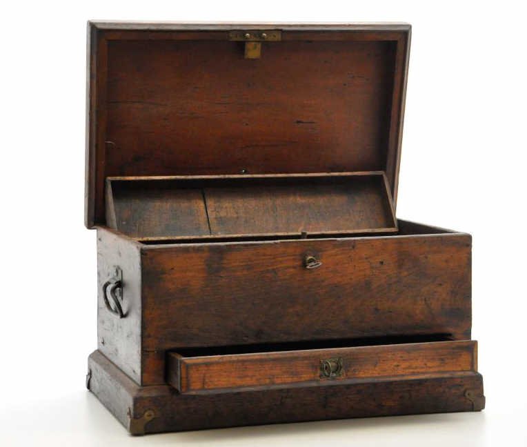 Wooden Machinist's Chest: An early wooden machinist's chest, with a drawer and original working lock and key. 21” long, 12” wide, 12” tall. There is a sliding tray inside the chest, and the entire box has been stripped o