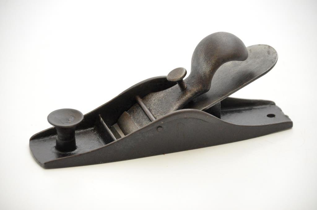 Iron Block Plane: 7” long coffin shaped block plane. The blade is stamped 'Ohio Tool Co. Auburn New York.' There is a hole drilled in the back of the plane body. Condition: good