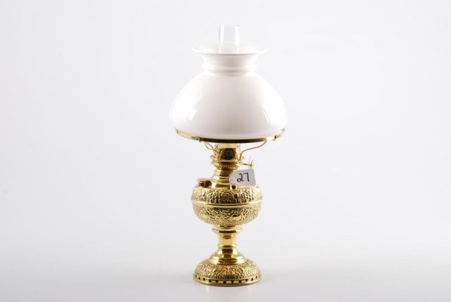 Demure Edward Miller Company Brass Table Lamp: Demure Edward Miller Company Embossed Brass Table Lamp. Height 16 inches. Condition: Good restored condition. Evidence of solder between foot and reservoir. Shade and chimney replaced at a later date.