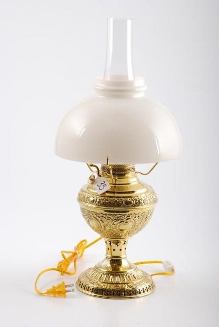 The New Juno Edward Miller Co. Brass Table Lamp: The New Juno brass table lamp by the Edward Miller Company, reticulated and embossed. Height 16 inches. Condition: Good: Minor chipping around top rim of shade. Electrified without harm to lamp.