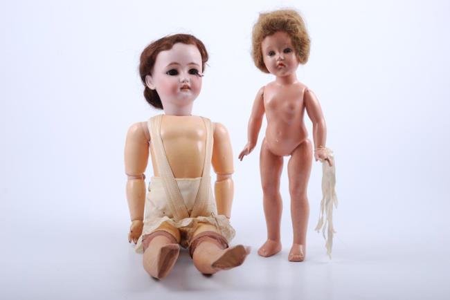 Two Simon and Haibig C.M. Bergman dolls: one doll compo body 11 1/2"; Effanbee all compo body 15" Condition: 11 1/2" doll ey lashes lashes, body very good with some soil; 15" doll light chipping, broken fingers and crazing.