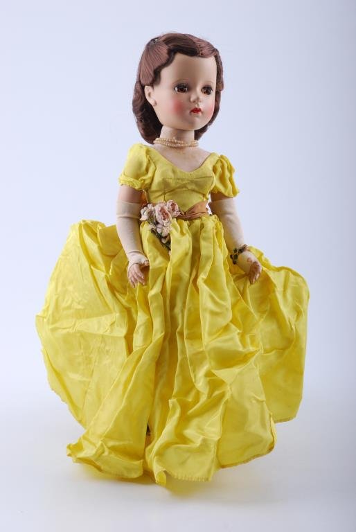 Madame Alexander Cissy doll: Wears tagged dress, gloves, bracelet, gold shoes, stockings; has a pretty face. Condition: As is, odors, doll has staining on legs, chest; dress crumpled