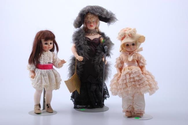 Three dolls on stands: One (1) Effanbee Mae West with tags Madame Alexander. One (1) Renoir- no box. One (1) Madame AlexanderDegas- no box. Condition: Alexander dolls have soiled clothing