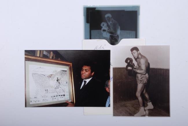 Group of (2) Muhammad Ali Negatives: Group of (2) Muhammad Ali Negatives One (1) 5" x 4" negative and print of Ali posing in his boxing gear. One (1) 2" x 2" color negative with a 4" x 6" print showing Ali displaying his artwork. Provena