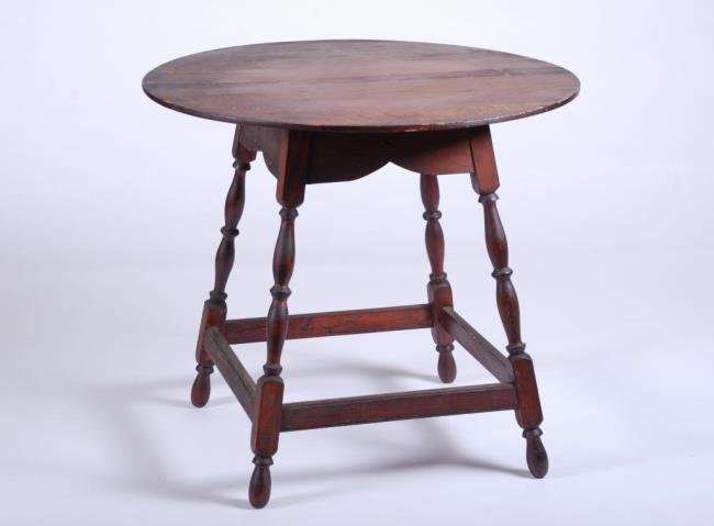 18th/19thc. Pine Queen Anne Tap Table: Oval pine top, block and turned splayed legs connected by a molded box stretcher and turned feet. 25 1/2 x 28 1/2 (diameter) Condition: Restored