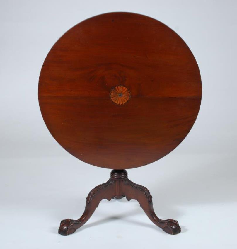 Mahogany Tip Top Tea Table: Chippendale style with marquetry inlay pinwheel top, turned and reeded pedestal, acanthus carved legs and ball and claw feet. Height 26 x 30 1/2 inches. Condition: Wear to marquetry, split to top thro