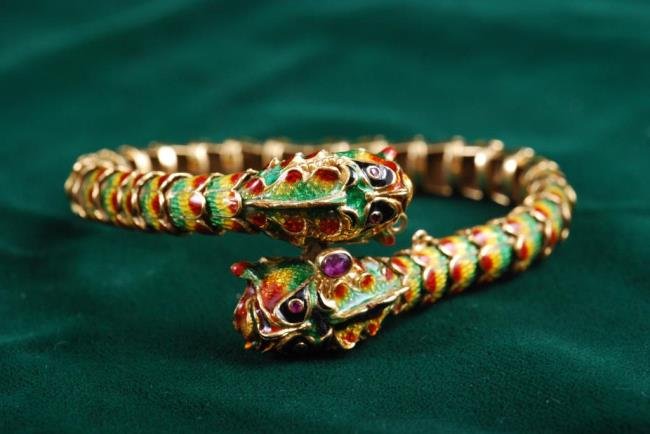 18K Gold Enamel Serpent Bracelet: 18K gold Italian flexible polychrome enamel serpent bracelet set with ruby eyes and ruby clasp. Condition: Good Size: Interior approx. 6 1/2 inches, width at clasp approx. 1 inch, 24.6 dwt.