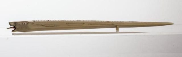 PACIFIC NORTHWEST INUIT POLAR BEAR FORM CRIBBAGE BOARD: Signed" "Made by David Seppilu date: Nov. 3,1963, SAVOONGA, ALASKA". Scrimshawed walrus, whale, sleds. Tongue removable to access (5) paddle-shaped game pegs. Length 21 inches
