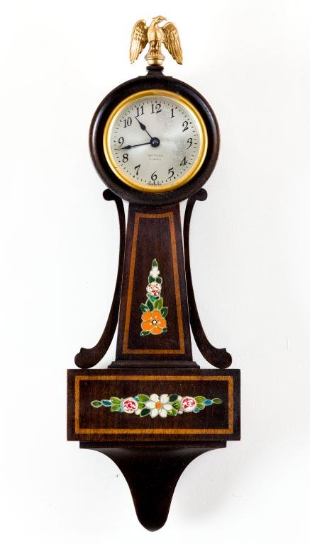 SETH THOMAS "DOVER" MINIATURE BANJO TIMEPIECE: Mahogany case. Gold border and colored flowers in panels. 8-day 4-jewel lever movement. (A variation of the ""Danvers"" Height 18 1/2 inches