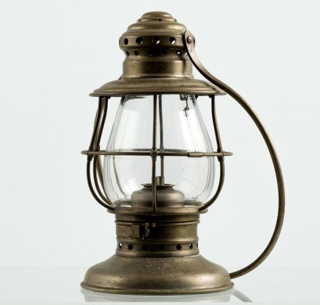 NICKEL-PLATED FIREMAN'S LANTERN: Nickel-plated brass lantern fitted with a whale oil burner. Blown molded globe is protected by a wire cage. Large hoop swing handle and cupped foot engraved "W" and on lid engraved "G.W. White" Height