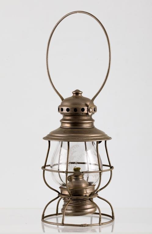 EXEMPLARARY S.B. UNDERHILL FIREMAN'S LANTERN: Nickel plated lantern with swing handle, globe cage, hinged vented lid and circular caged base. Font nests in wire frame. Base of font is stamped "S.D. Underhill New York 1865". Globe acid etched "Cap