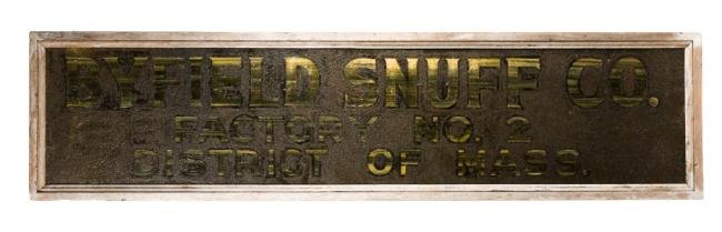 "BYFIELD SNUFF COMPANY FACTORY NO. 2" SIGN: Wooden sign with layers of over-paint and retouched grained lettering on a black sand laden-paint field. Provenance:Directly from the snuff factory on the Parker River. 17 x 68 inches