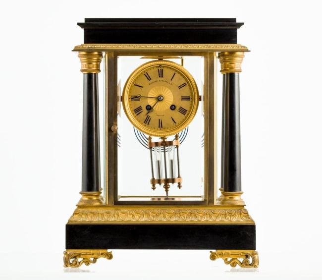 FRENCH EMPIRE ONYX AND GILT-BRONZE SHELF CLOCK: Gilt dial signed Bigelow Kennard & Co. Boston, beveled glass front, sides and back, four onyx columns bind cast gilt bronze entablature to an onyx base capped with cast gilt bronze all resting on gilt