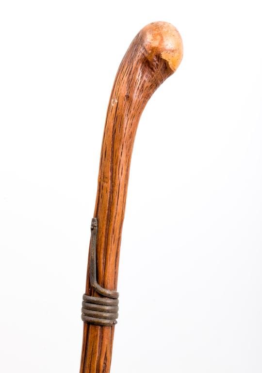 CANE OF EXOTIC WOOD WITH BRONZE SNAKE COLLAR: Single piece of natural wood with polished knob handle. Steel ferrule Length 35 inches