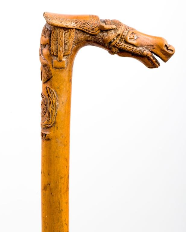 HORSE CARVED "SOUVENIK CORFUVA" CANE: 4 inch carved ""L"" handle in the form of a horse with a hirsute gent carved into the top of the turned shaft. Thimble form ferrule. Length 37 inches